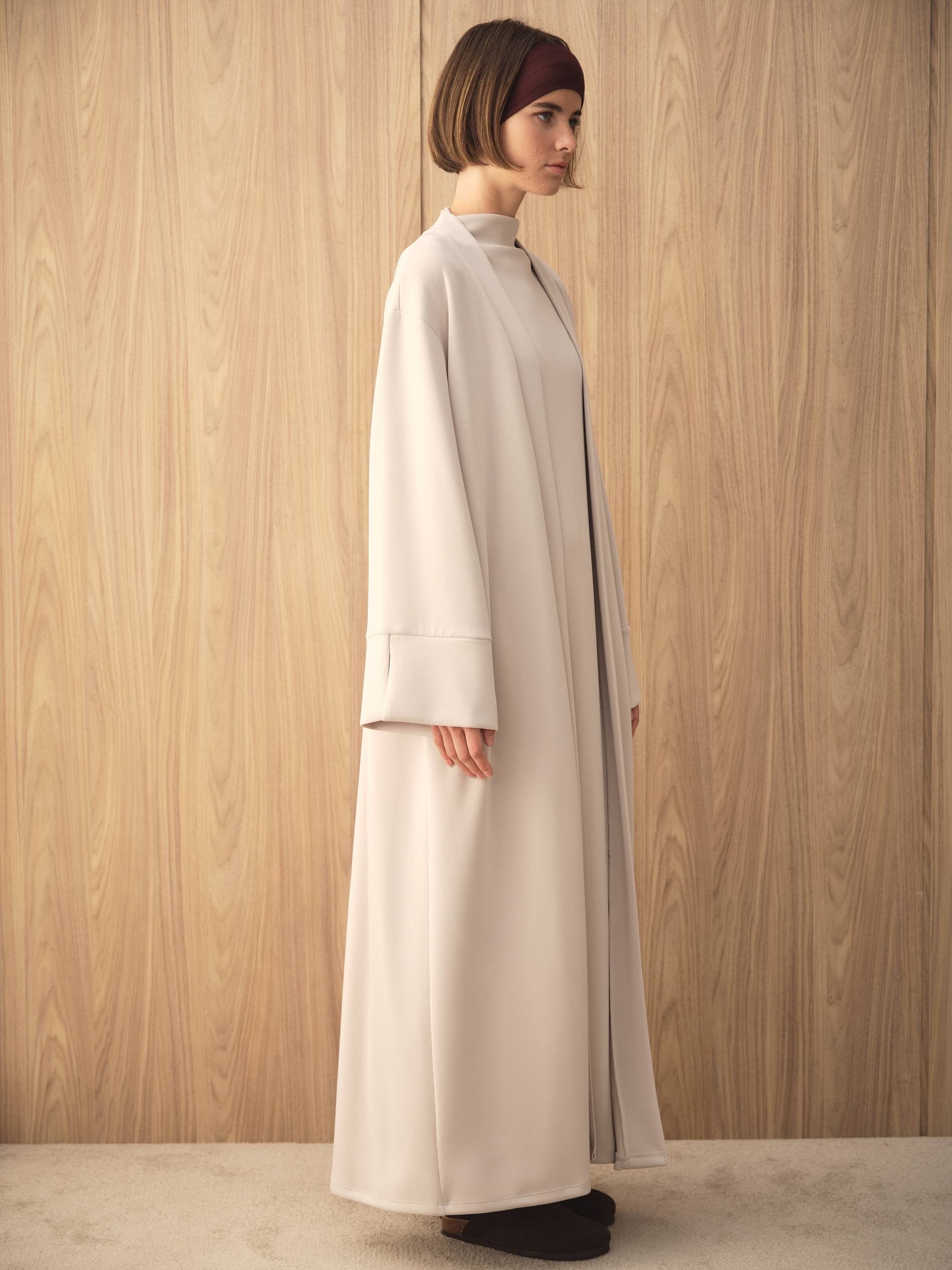 MOVE 01 Modal Stretch Abaya Set in Cloud Ecru, side view showing the oversized silhouette.